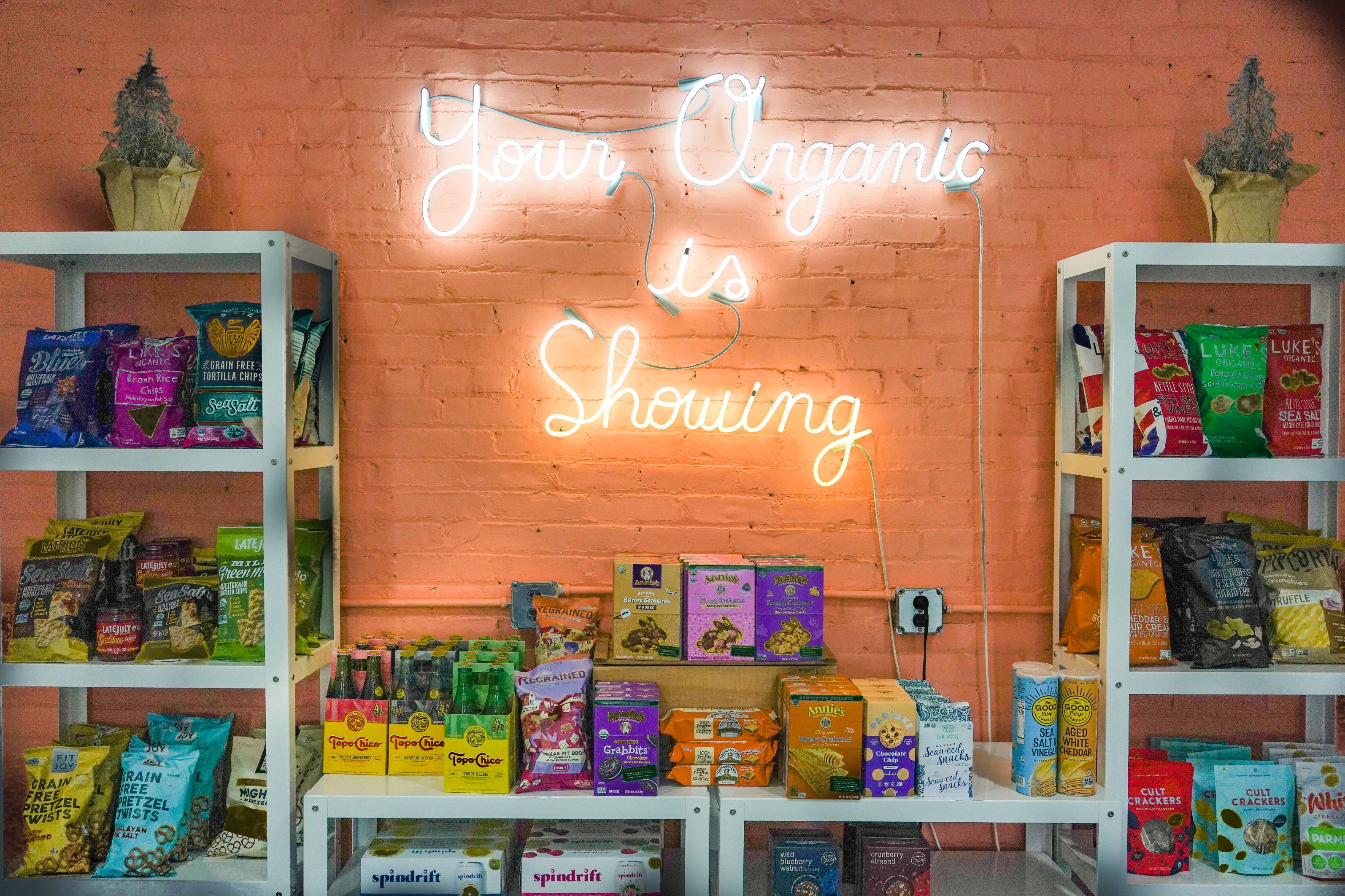 Mike's Organic shop neon sign and food display