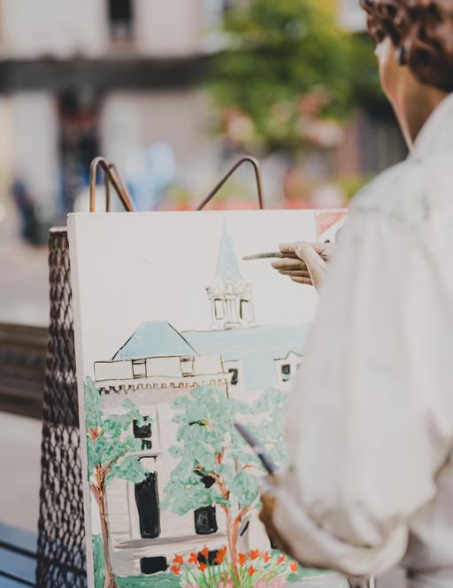 artist paining in street